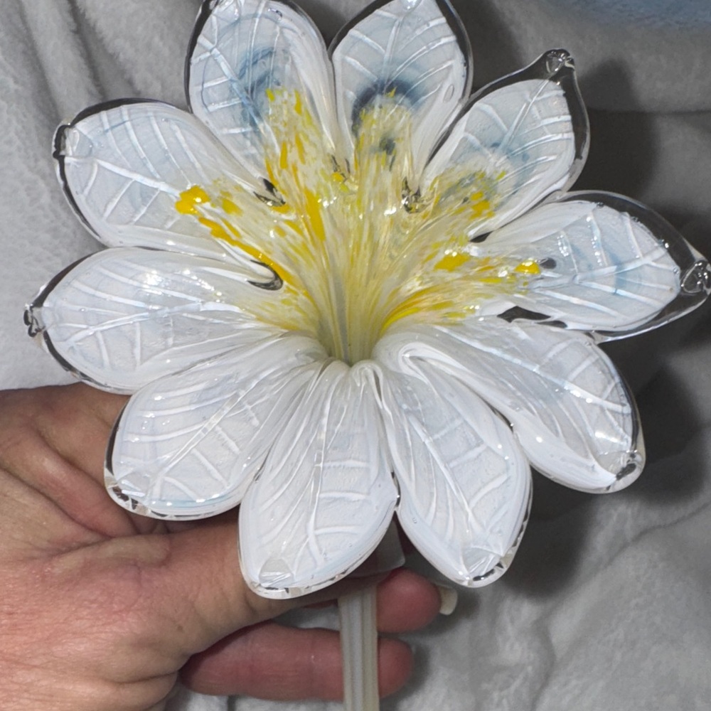 A vintage hand-blown Murano glass flower with a long stem.